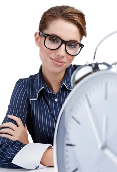 Young businesswoman with a big clock Stock Image
