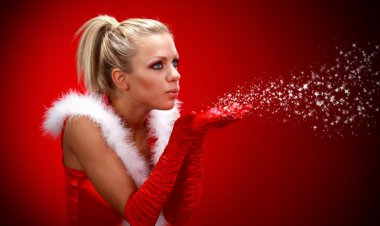 Attracive sexy girl in santa cloth blowing snow from hands. clipart