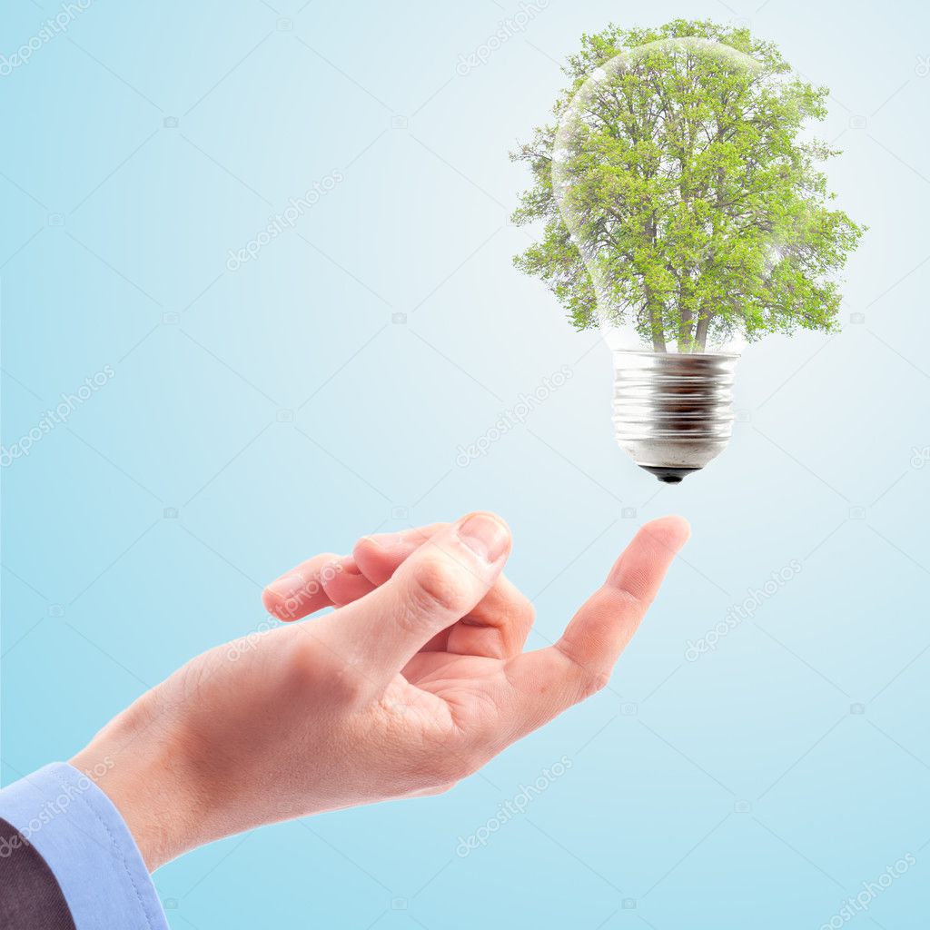 Hand with lamp and tree.