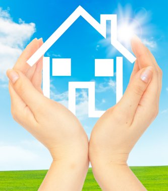 Hands holding model of a house clipart