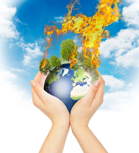 Womanish hands holding burning Earth. — Stock Photo, Image