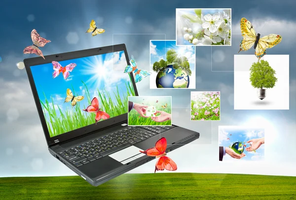 Laptop yeşil doğaya karşı kolaj — Stok fotoğraf