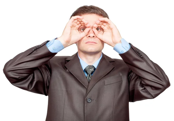 Businessman making binoculars with hands and looking through — Stock Photo, Image