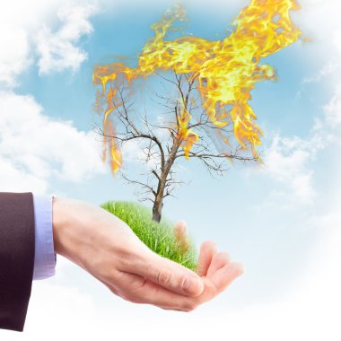 Human hand holding a piece of nature in flames clipart