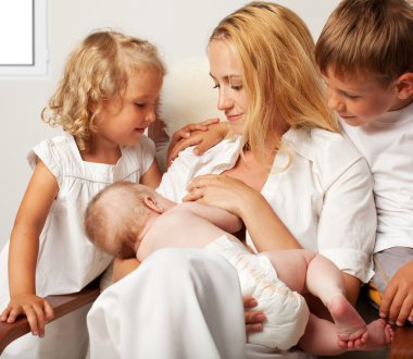Mother breastfeeding her baby clipart