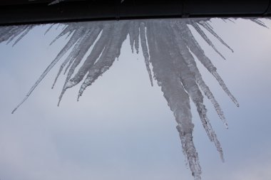 Icicles on roof in cols winter clipart