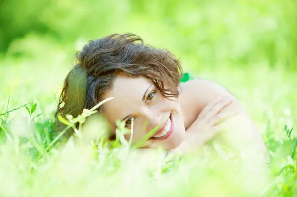 Girl lies on lawn — Stock Photo, Image
