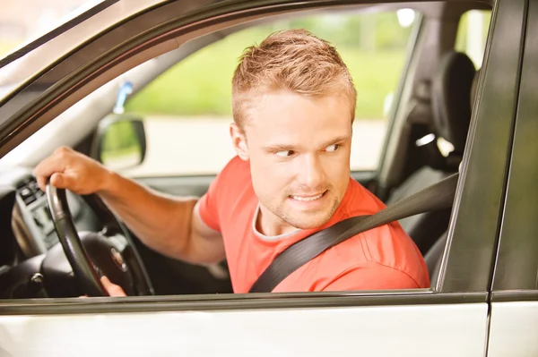 Driver of car looks back — Stock Photo, Image
