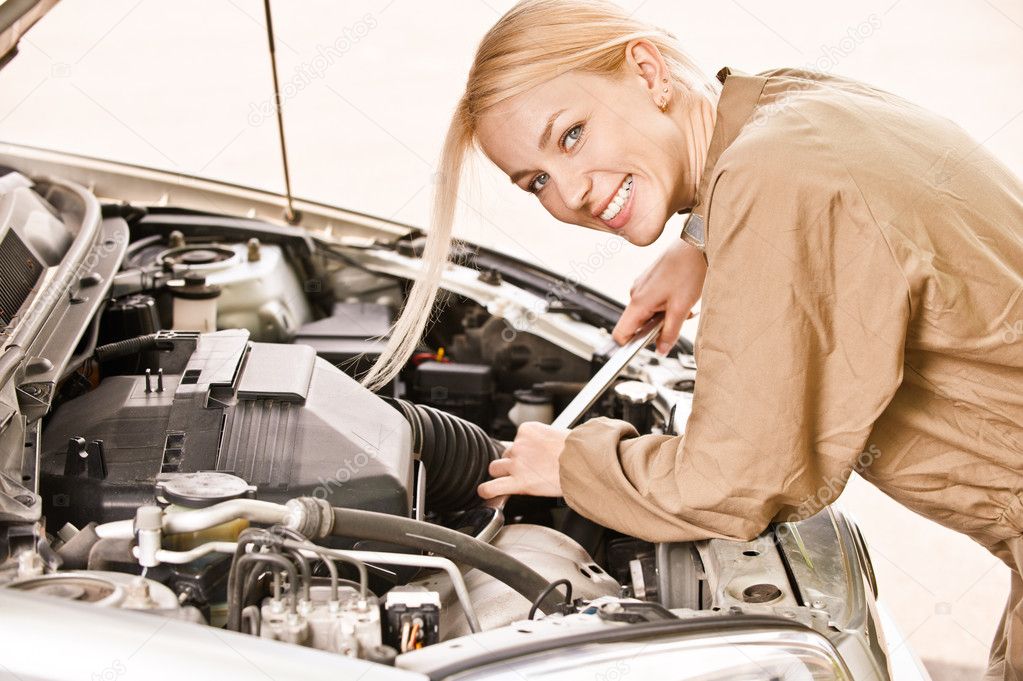 Car mechanician repairs engine