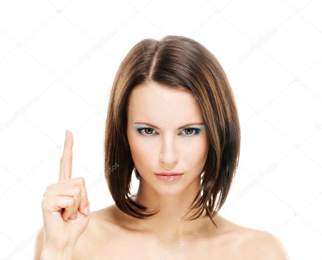 Woman with bared shoulders lifts upwards forefinger