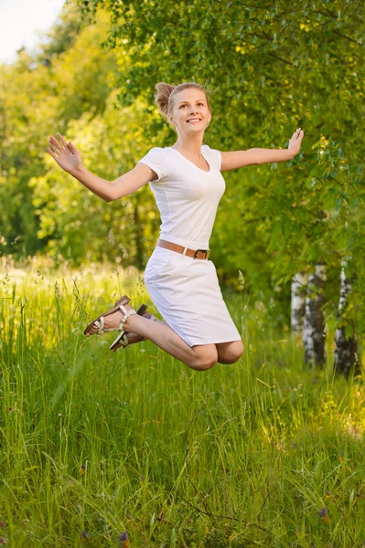 Жінка стрибає вгору і сміється — стокове фото