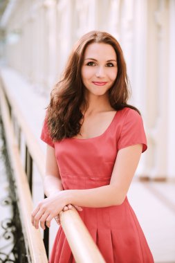 Woman in red dress about handrail clipart