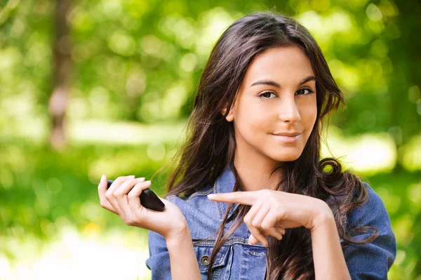 Portrait of beautiful young long-haired woman with mobile phone — Stock Photo, Image