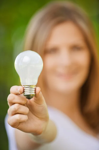 stock image Portrait of woman holding lamp