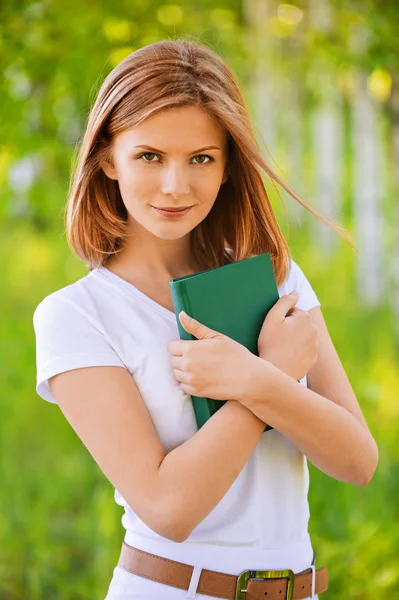 Portrait of beautiful young blond woman with book — Stock Photo, Image