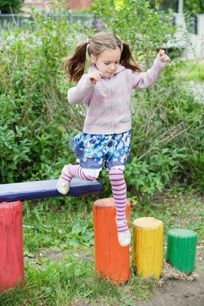 Маленькая милая девочка на детской площадке — стоковое фото
