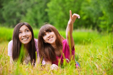 Two young women stare to the sky clipart