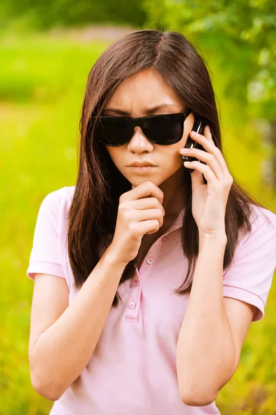 stock image Portrait of woman in sunglasses with phone