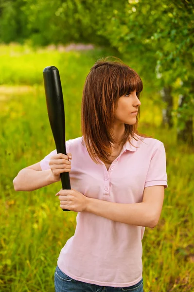 Portrait of young woman with bat — Stock Photo, Image