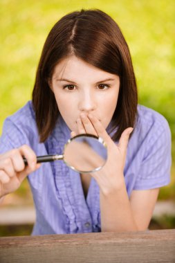 Portrait of young woman with loupe clipart