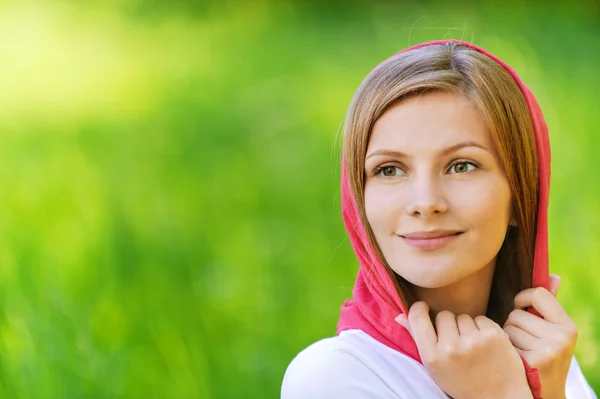 Portrait of young smiling woman wearing kerchief — Stock Photo, Image