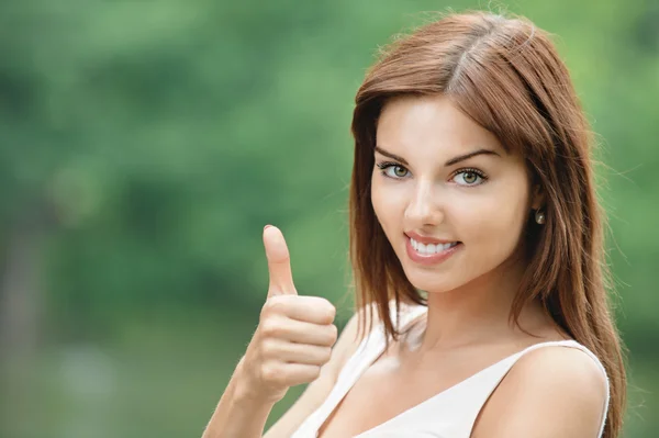 Portrait of young woman showing "thumbs-up" sign — Stock Photo, Image