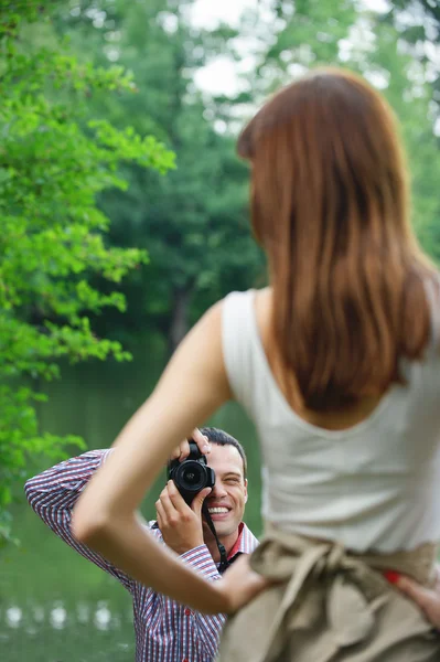 Young photographer takes photo of woman — Stock Photo, Image