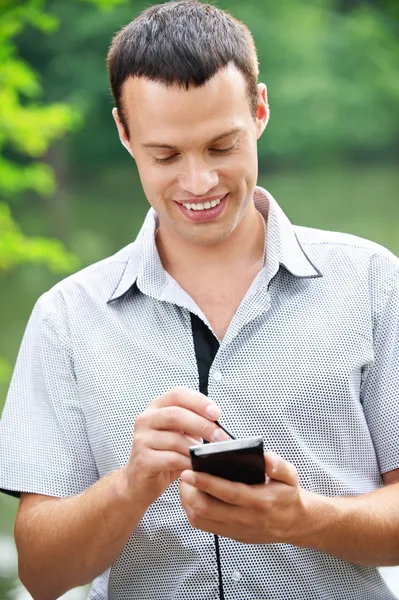 Young man holding smartphone — Stock Photo, Image