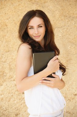 Portrait of brunette woman holding book clipart