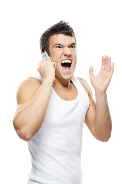 Portrait of young man shouting on mobile telephone — Stock Photo, Image