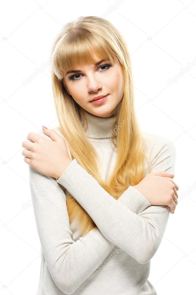 Portrait of young alluring blonde woman embracing herself