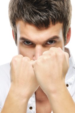 Close-up portrait of young man holding fists clipart