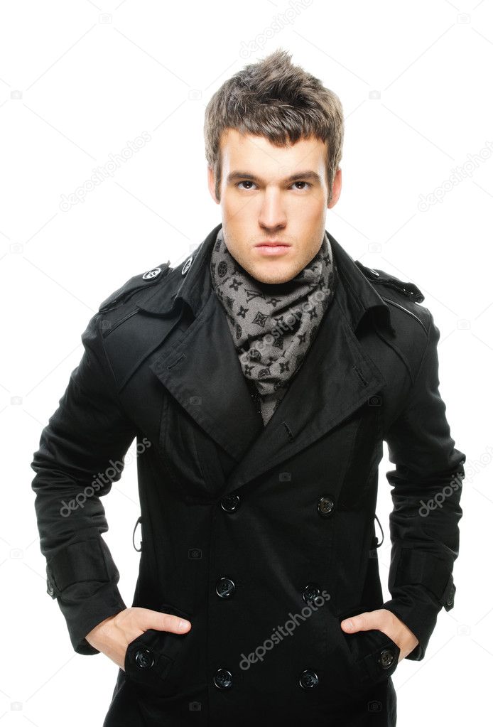 Poirtrait of young serious man wearing raincoat