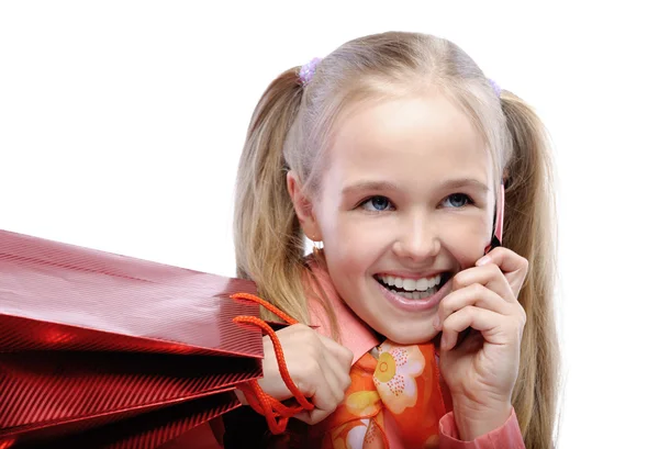 Portrait of little laughing girl holding several packets — Stock Photo, Image
