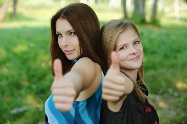 Two young women showing "thumbs-up sign" — Stock Photo, Image