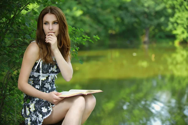 Portrait of young woman holding book — Stock Photo, Image
