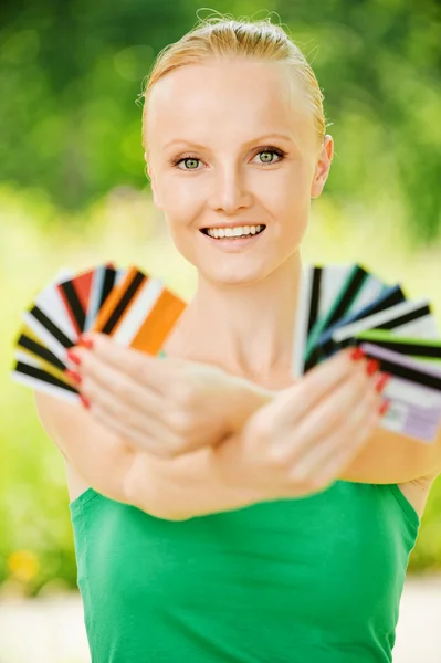 Portrait of woman holding colourful cards — Stock Photo, Image