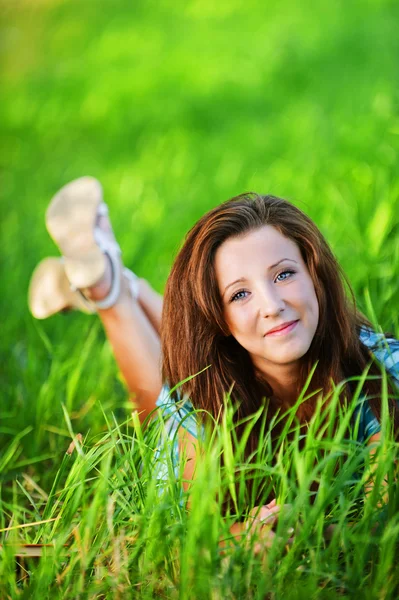 Красивая девушка, лежащая на траве — стоковое фото