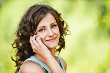 Beautiful woman speaking on mobile phone clipart