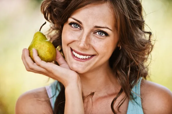 Portrait of woman holding pear — Stock Photo, Image