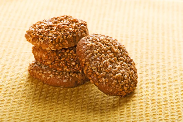 Cookies with sesame seedson on yellow — Stock Photo, Image
