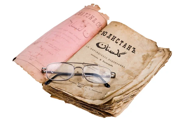Old book with glasses on white — Stock Photo, Image