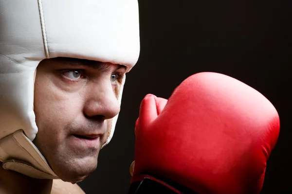 Boxer in helmet and boxing gloves — Stock Photo, Image
