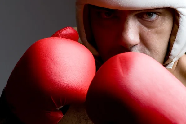 Boxer in helmet and boxing gloves close up — Stock Photo, Image