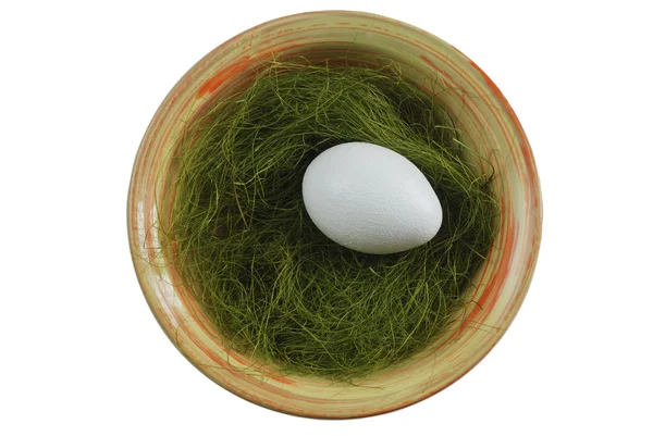 Egg in a plate with green grass over white — Stock Photo, Image