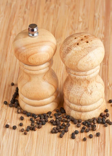 Salt och peppar slipmaskiner på ett bord — Stockfoto