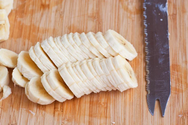 Freshly sliced bananas and knife — Stock Photo, Image