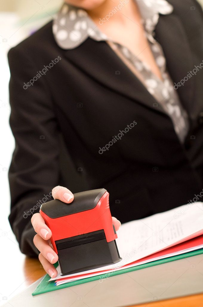 Woman's hand with stamping documents