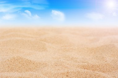 Sand and sky with clouds and sun clipart