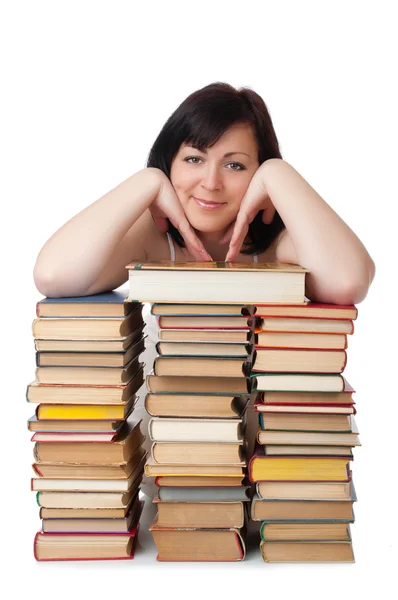 Ung leende kvinna med hög med böcker — Stockfoto